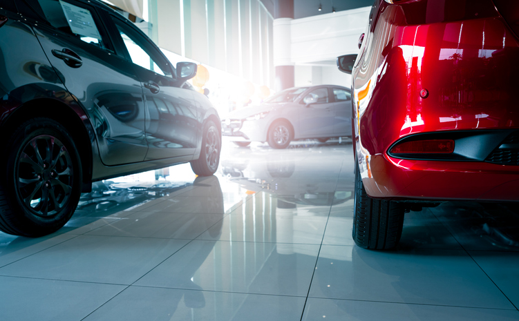 A stylish electric car parked inside a luxury dealership office where customers browse and rent automobiles in a modern showroom showcasing clean energy technology and urban transportation innovation.
